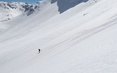 People skiing on snow covered land