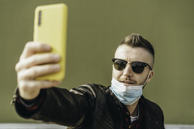 Portrait of young man using mobile phone