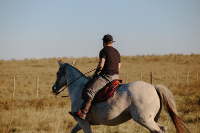 Man riding horse on field