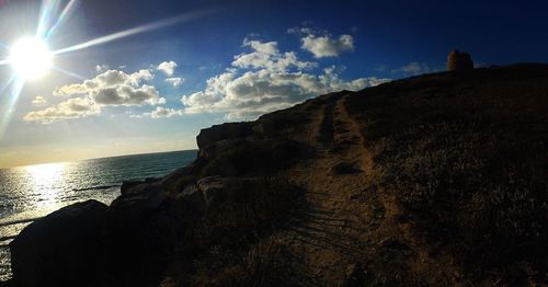 Scenic view of sea against bright sun