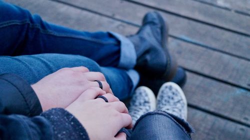 Low section of couple sitting outdoors