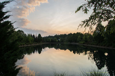 Scenic view of lake against sky at sunset