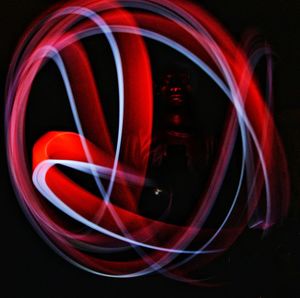 Digital composite image of light painting against black background