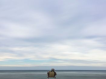 Man on beach against sky