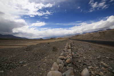 Surface level of barren land against sky