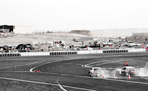 People on airport runway against clear sky in city
