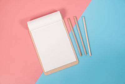 High angle view of paper against blue background