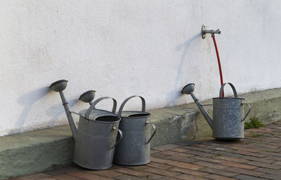 The photo shows several colorful children's shovels in the sun