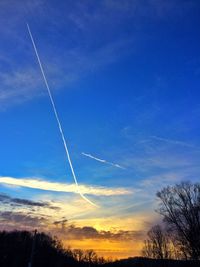 Low angle view of vapor trails in sky