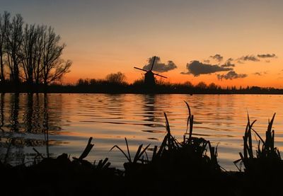 Scenic view of lake against orange sky