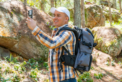 Portrait of man standing in forest
