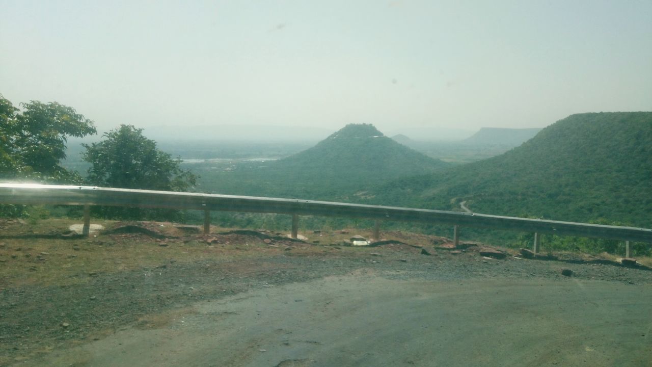 SCENIC VIEW OF LAND AND MOUNTAINS AGAINST SKY