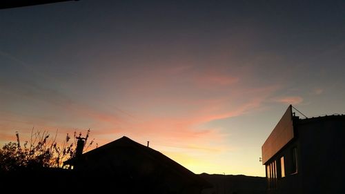 High section of building against sky at sunset