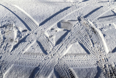 High angle view of tire tracks on snow