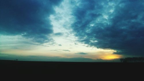 Scenic view of landscape against cloudy sky