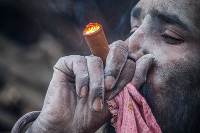 Close-up of man smoking cigar