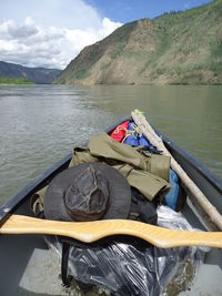 Man in boat on lake against mountain