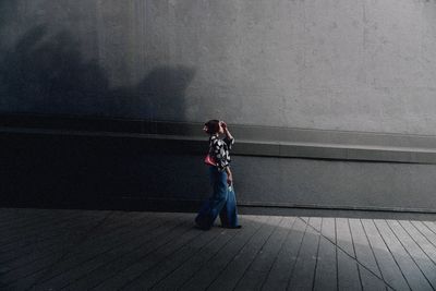 Rear view of woman walking on street