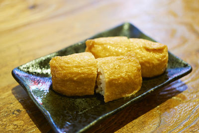 Close-up of snack in plate on wooden table