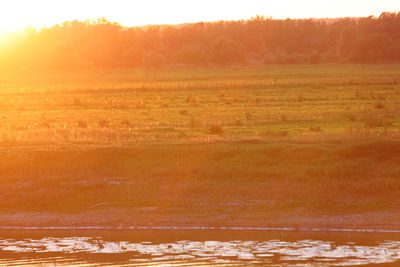 Scenic view of land against sky during sunset