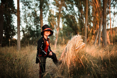 Portrait of boy wearing costume during halloween standing at forest