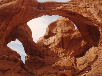 Low angle view of rock formations against sky