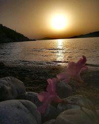 View of rocks at beach during sunset