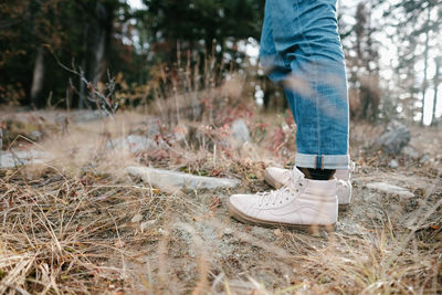 Low section of person standing on land