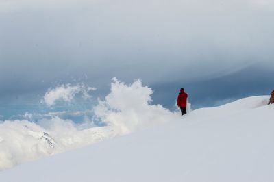 Man on snowcapped mountain against sky