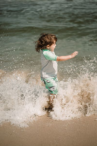 Full length of girl enjoying in sea