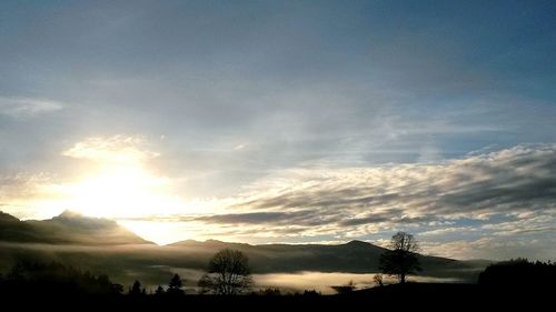 Scenic view of mountains against sky at sunset