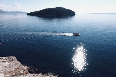 High angle view of boat sailing on sea against sky