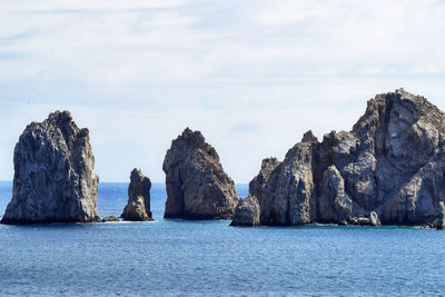 Scenic view of sea and rock formations against sky