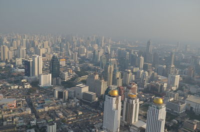 High angle view of modern buildings in city against sky