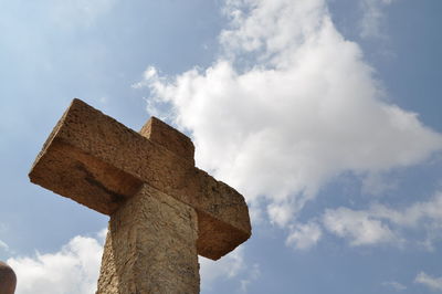 Low angle view of cross against sky