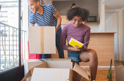 Young couple holding hands sitting in box