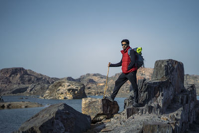 Full length of man standing on rock