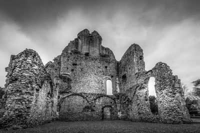 Low angle view of old building ruins against sky