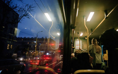 People on illuminated street at night