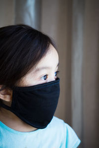 Girl wearing mask at home