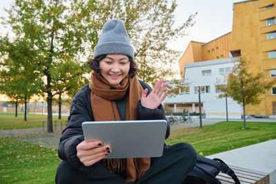 Portrait of woman using digital tablet