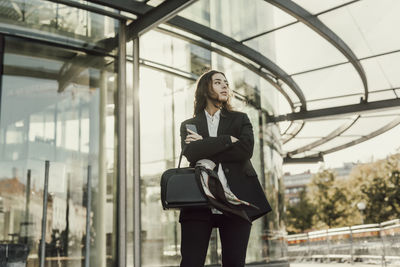 Full length of a young woman using phone