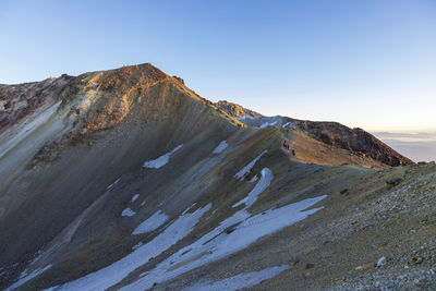 Scenic view of rocky mountains against clear sky