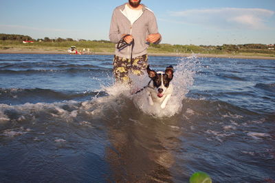 Man with dog in the sea