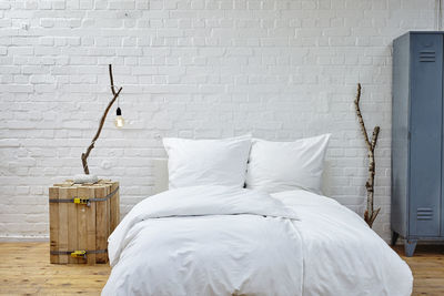 White blanket on bed against wall at home