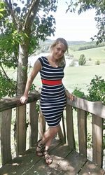 Portrait of a girl standing on tree trunk