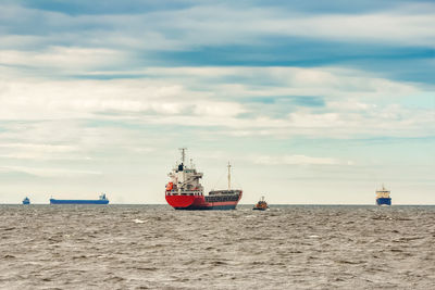 Nautical vessel on beach against sky