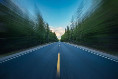 Cascade lakes highway oregon . empty lane highway through forest. selective blur