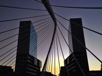 Low angle view of suspension bridge against sky