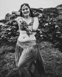 Portrait of a smiling young woman on field